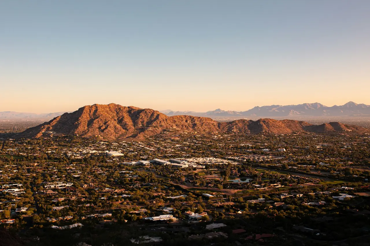 Phoenix spread out below desert mountains at dusk